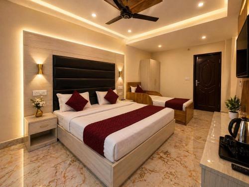 a hotel room with two beds and a ceiling at Grand Vista Retriet- A luxury Mountain View Property In Mussoorie By Lilly in Mussoorie