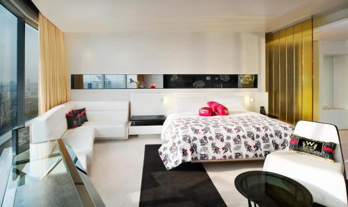 a bedroom with a bed with red pillows on it at W Bangkok Hotel in Bangkok