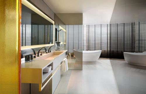a bathroom with two sinks and two toilets at W Bangkok Hotel in Bangkok