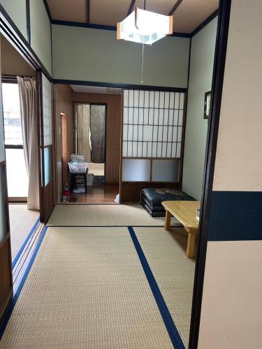 a living room with a couch and a table at ゲストハウスぬっく in Tanabe