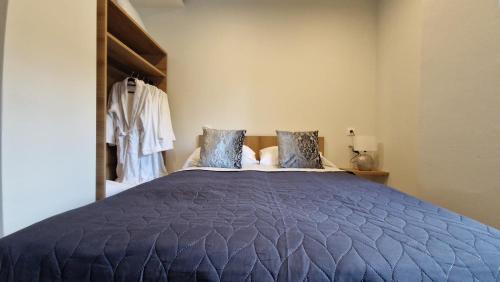 a bedroom with a large blue bed with pillows at Milaluxe in Paralia Katerinis