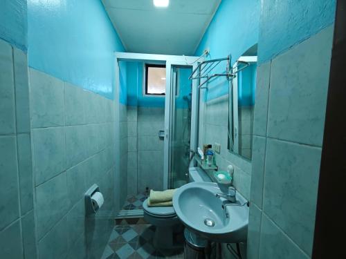 a bathroom with a sink and a toilet at Sangria Pinesview Chalet in Baguio