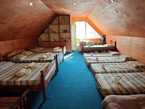 a room with a bunch of beds in it at Sangria Pinesview Chalet in Baguio