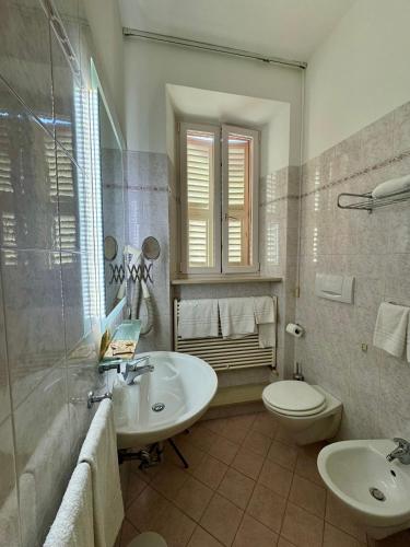 a bathroom with a sink and a toilet at Camere LAURO ROSSI in Macerata