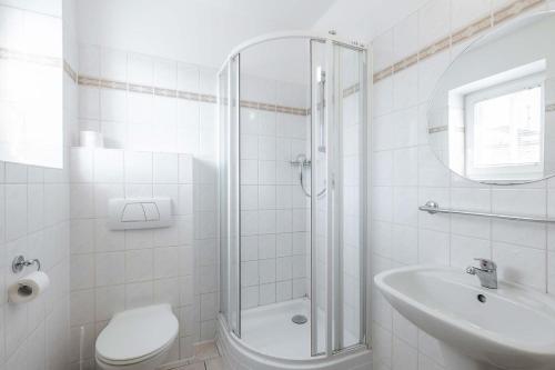 a bathroom with a shower and a toilet and a sink at Hotel Morava Jevíčko in Jevíčko