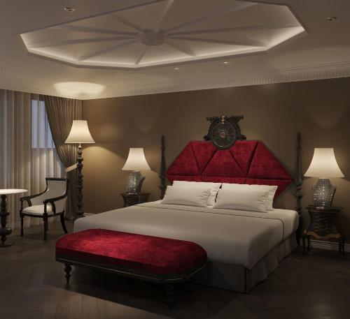 a bedroom with a large bed with a red headboard at Hôtel Le Joyau Bleu Hanoï in Hanoi