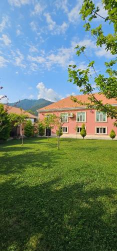 a pink house in a field of green grass at Green Garden RHB in Gabala