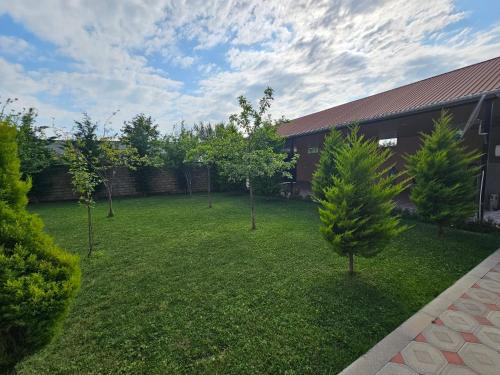 a yard with trees in front of a building at Green Garden RHB in Gabala