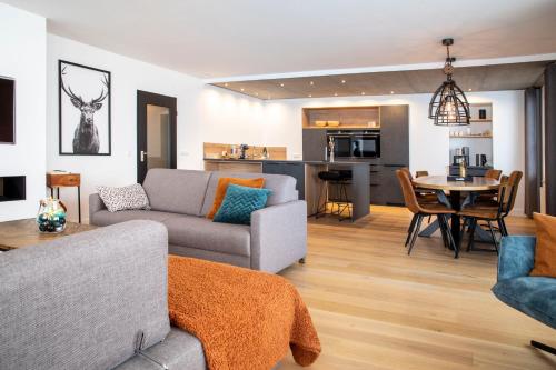 a living room with a couch and a table at Ferienwohnung Penthouse Feldberg in Feldberg