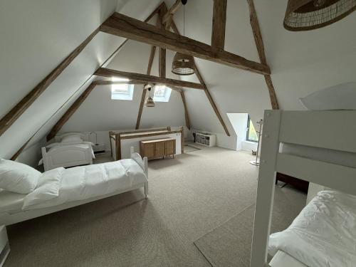 a attic room with two beds and a desk at Manoir de Cottentray Charming Manor in Avesnes-en-Bray