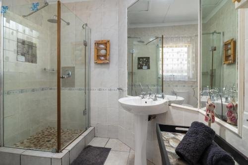 a bathroom with a sink and a shower at Blue Nautica Coastal Retreat in Ballito