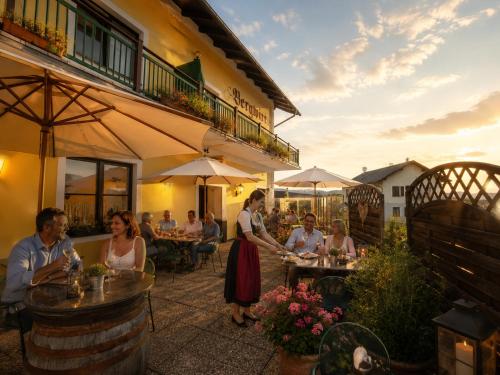 a group of people sitting at tables outside of a restaurant at Mohnhotel - Bergwirt Schrammel in Zwettl Stadt