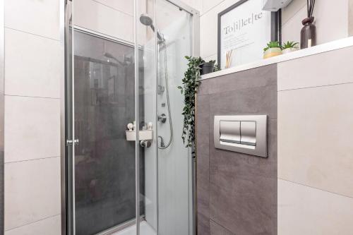 a shower with a glass door in a bathroom at Apartment Maja in Winterberg