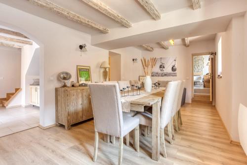 a dining room with a wooden table and chairs at L'écrin de Brévardière in Saint-Pierre-de-Chartreuse