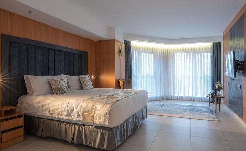 a bedroom with a large bed in a room at Iconic Plaza Hotel in Nairobi