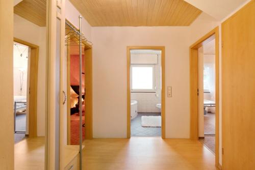 a hallway with a door leading to a bathroom at Sandra in Berghülen