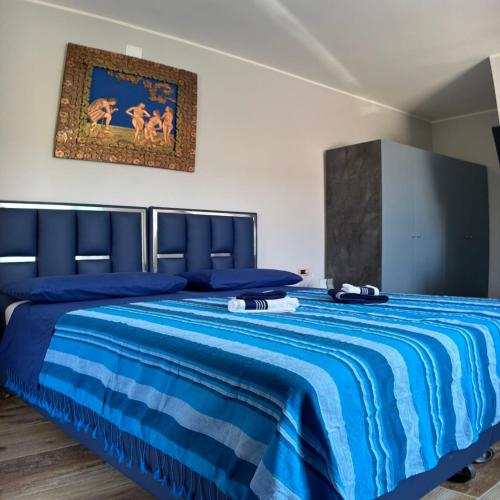 a bedroom with a blue bed with a blue comforter at Antiche Torri Guest House in Castel Volturno