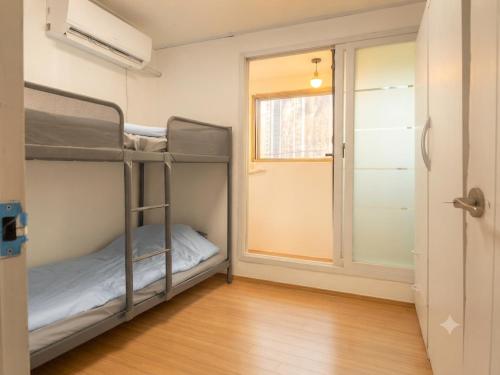 a room with two bunk beds and a window at BV House in Incheon