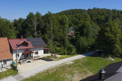 an overhead view of a house with solar panels on its roof at Mountain Escape house with indoor pool in Fužine