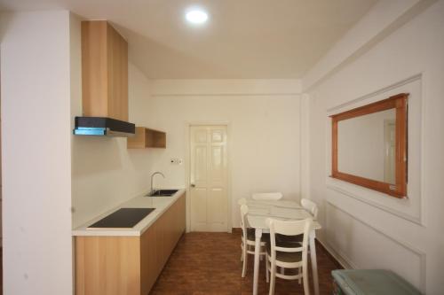 a kitchen with a counter and a table and chairs at New Sun Hotel in Da Lat