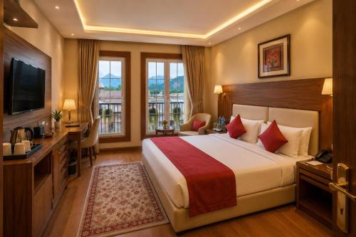 a hotel room with a bed and a television at The Rosendale Srinagar in Srinagar