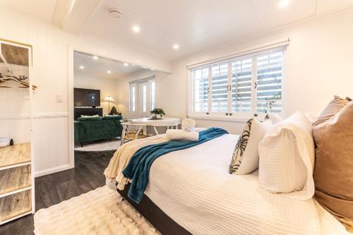 a bedroom with a large bed and a table at Urban Getaway Apartment Ipswich in Ipswich