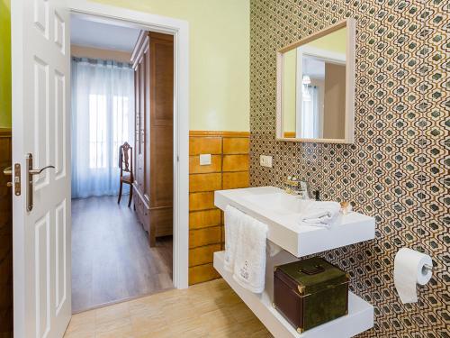 a bathroom with a white sink and a mirror at CASA LOS LAGARES in Moriles