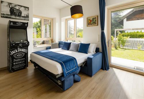 a bedroom with a bed and a large window at Rauchhof Apartments in Auer