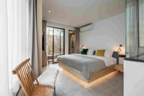 a bedroom with a bed and a large window at JIDMI HOTEL in Xiamen