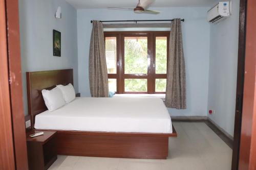 a bedroom with a bed and a window at Luxury Villa Large Private Pool in Raichak