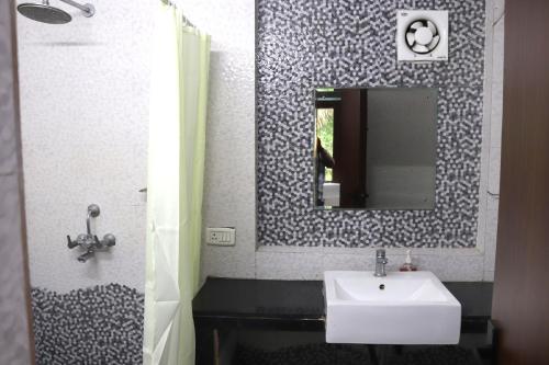 a bathroom with a sink and a mirror at Luxury Villa Large Private Pool in Raichak