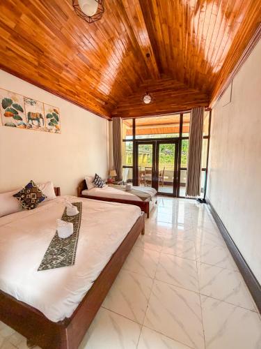 a bedroom with two beds and a living room at Nongkhaiw Hostel in Nongkhiaw