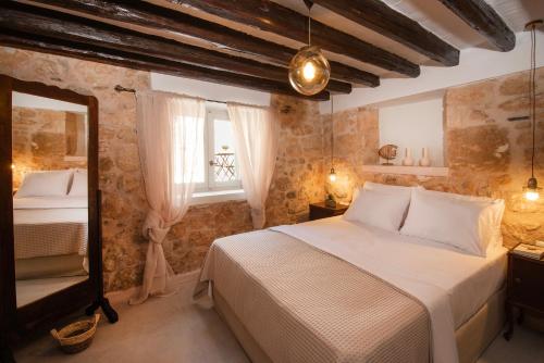 a bedroom with a bed and a window at Amalthea Guest House in Egina