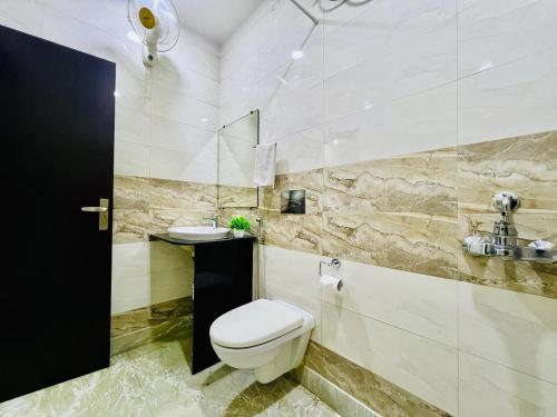 a bathroom with a toilet and a sink at BluO Lake View NewTown - Boutique Hotel in Kolkata