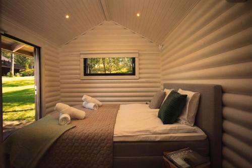 a bed in a small room with a window at Stay North - Ösund in Helsinki