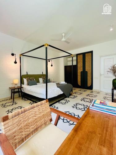a living room with a bed and a table at SolVanya by evaddo stays 2BHK Luxury Villa with Private Pool in Siolim in Siolim