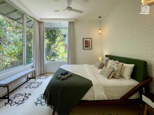a bedroom with a large bed and a window at SolVanya by evaddo stays 2BHK Luxury Villa with Private Pool in Siolim in Siolim