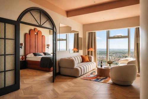 a bedroom with a bed and a mirror at Apartamenty Sky Tower in Wrocław