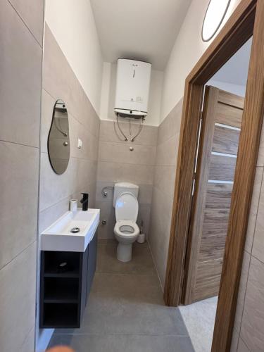a small bathroom with a toilet and a sink at Zadar Sunhouse Studio with Terrace in Zadar