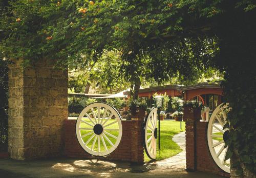a brick fence with two largewheels on it at Hermitage Hotel & Resort Forte dei Marmi - Starhotels Collezione in Forte dei Marmi