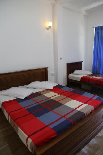 a bedroom with two beds in a room at VRK Adventure Basecamp Sri Lanka in Kitulgala