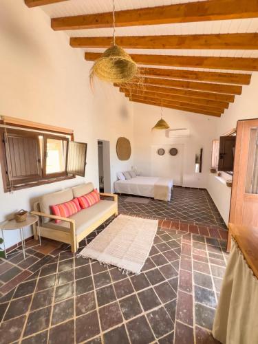 a living room with a couch and a table at Palmeira Nature Lodge in Tavira