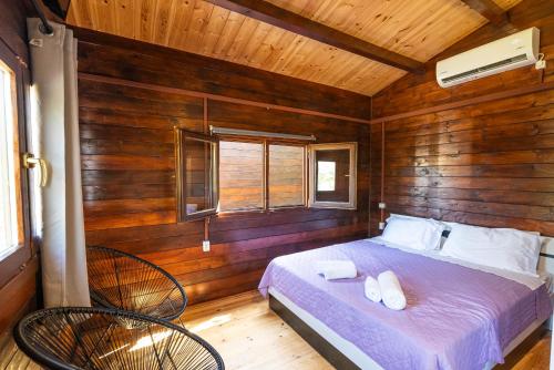 a bedroom with a bed and two chairs in a room at Golden Sun Villas in Nydri