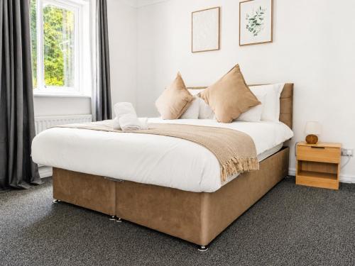 a bedroom with a large bed with white sheets and pillows at iblets in Gravesend