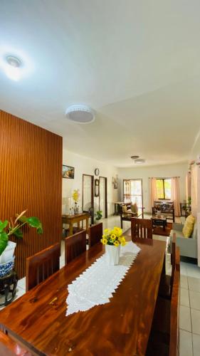 a living room with a wooden table and a dining room at MacCreek in Macrohon