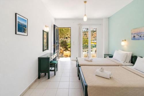 a hotel room with two beds and a balcony at Villa Zefiros in Kipri