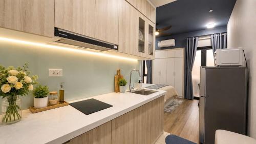 a kitchen with a sink and a refrigerator at JOY APARTMENT TAY HO in Hanoi