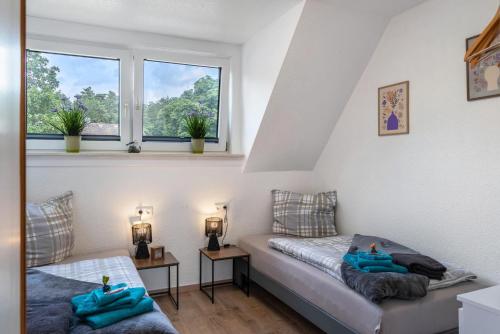a small room with a bed and a window at Tanne in Sprakensehl