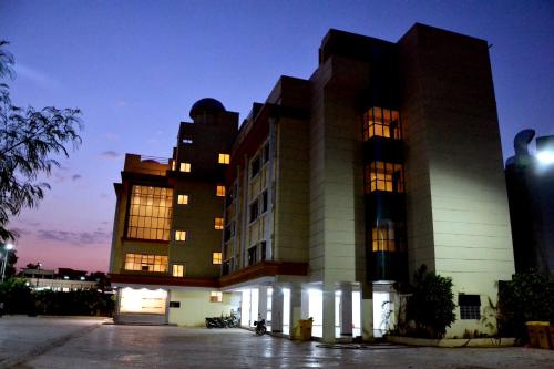 a building with lights on in front of it at Hotel City Heart Shirdi in Shirdi