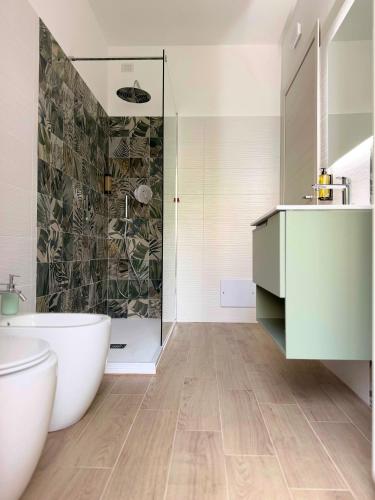 a bathroom with a tub and a sink and a shower at Tra 2 Blu Guest House in Belvedere Marittimo